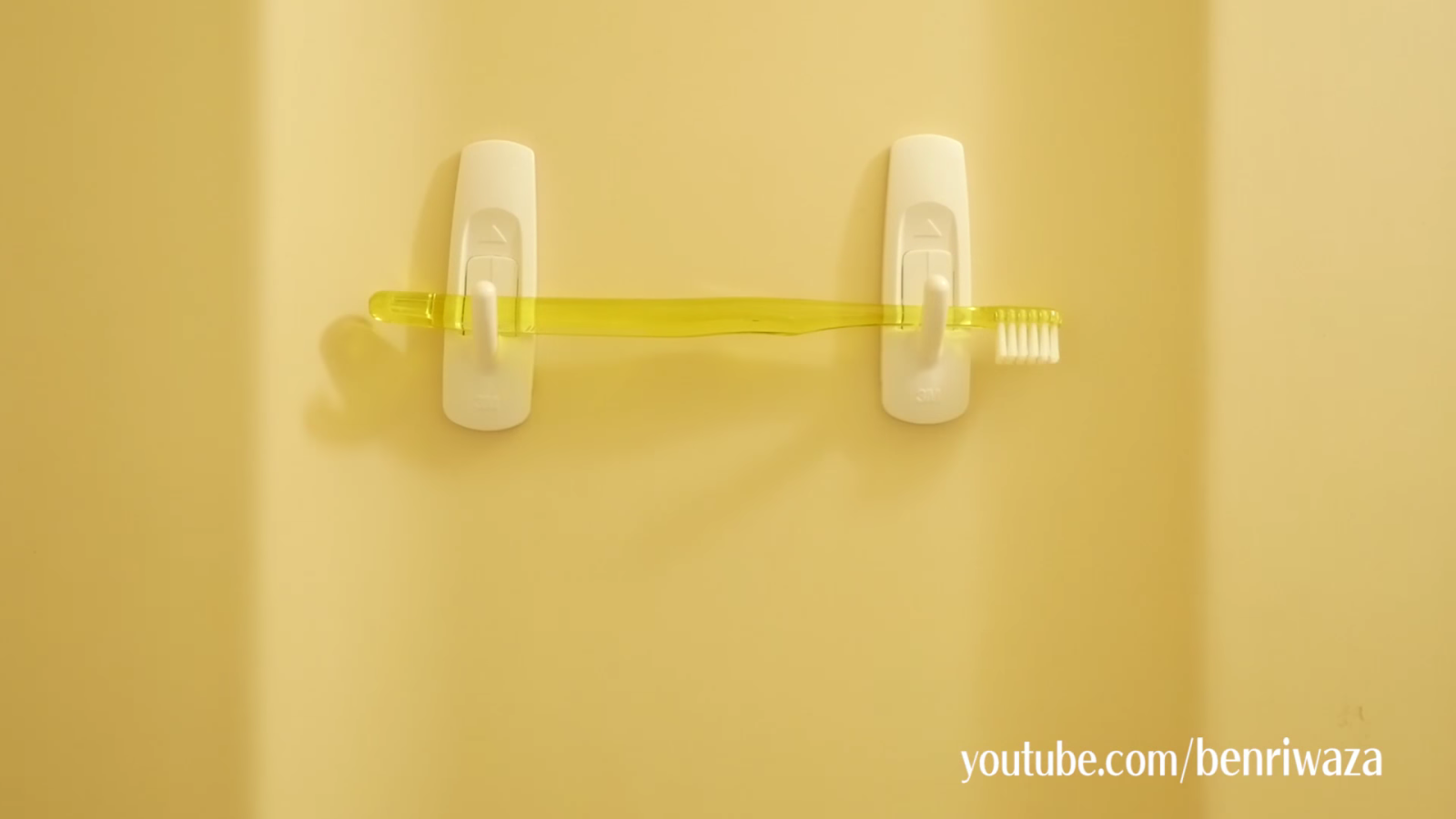 フックを使って洗面台に歯ブラシを収納する男性