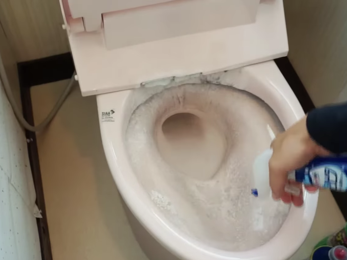 中性洗剤でトイレ掃除をする男性