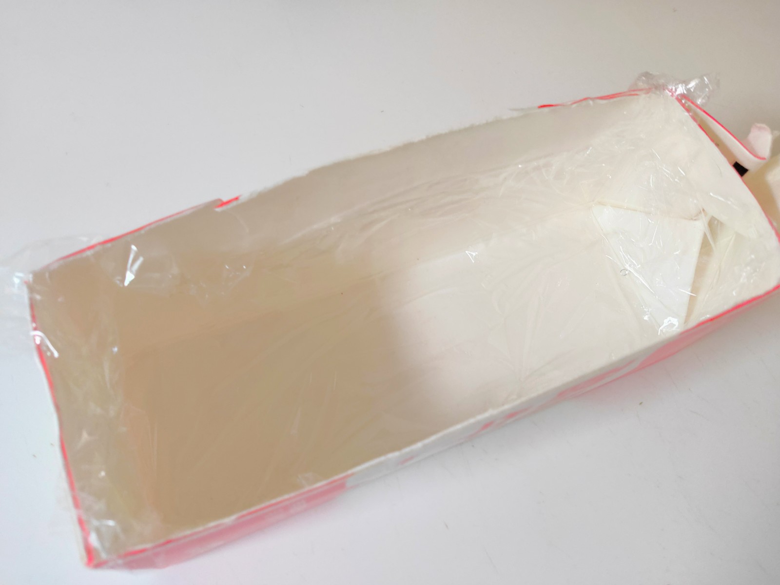 洗って、開け口の部分を閉じた状態の牛乳パックの側面の一部を切り取り、ラップを敷いたものを型として使用します。