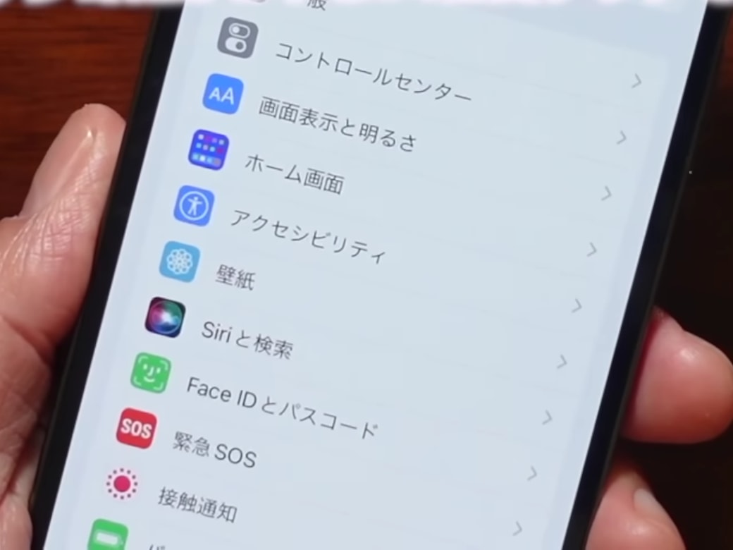 スマホのアクセシビリティの設定をする男性