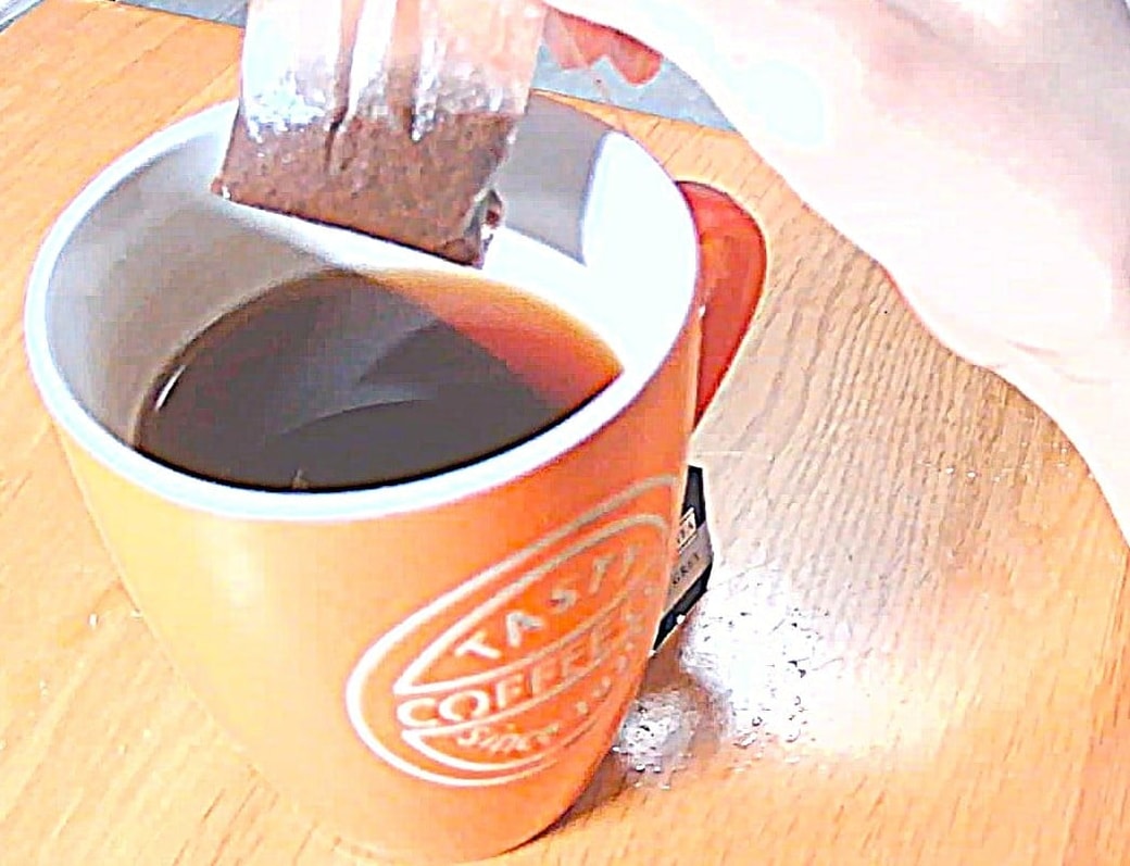 紅茶のティーバッグをゆっくり持ち上げる
