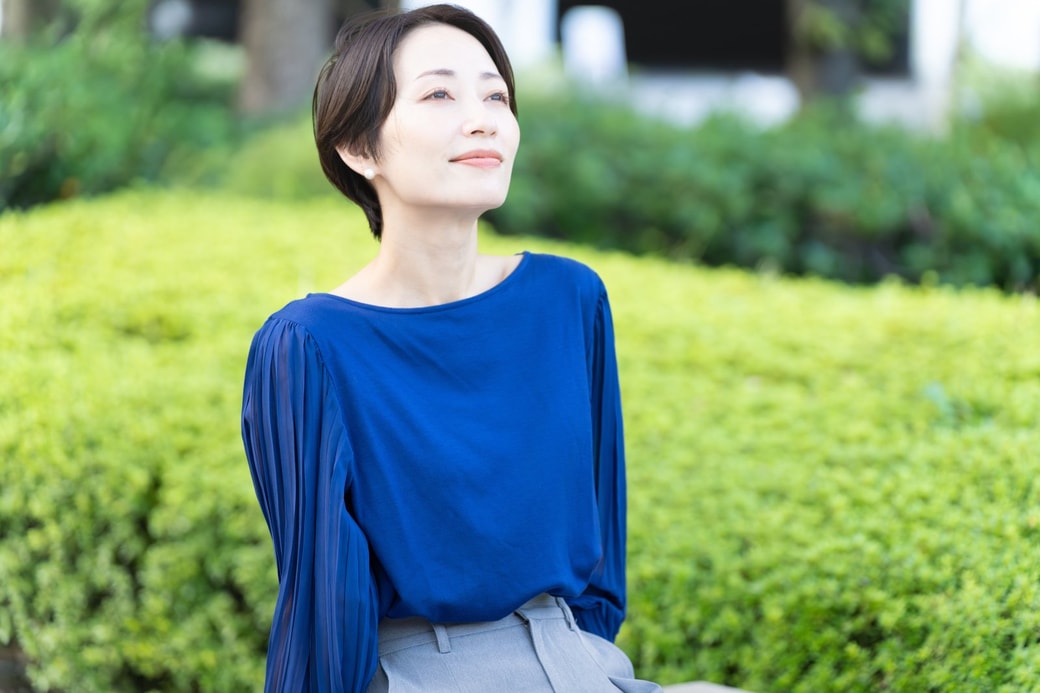 屋外で考え事をする女性