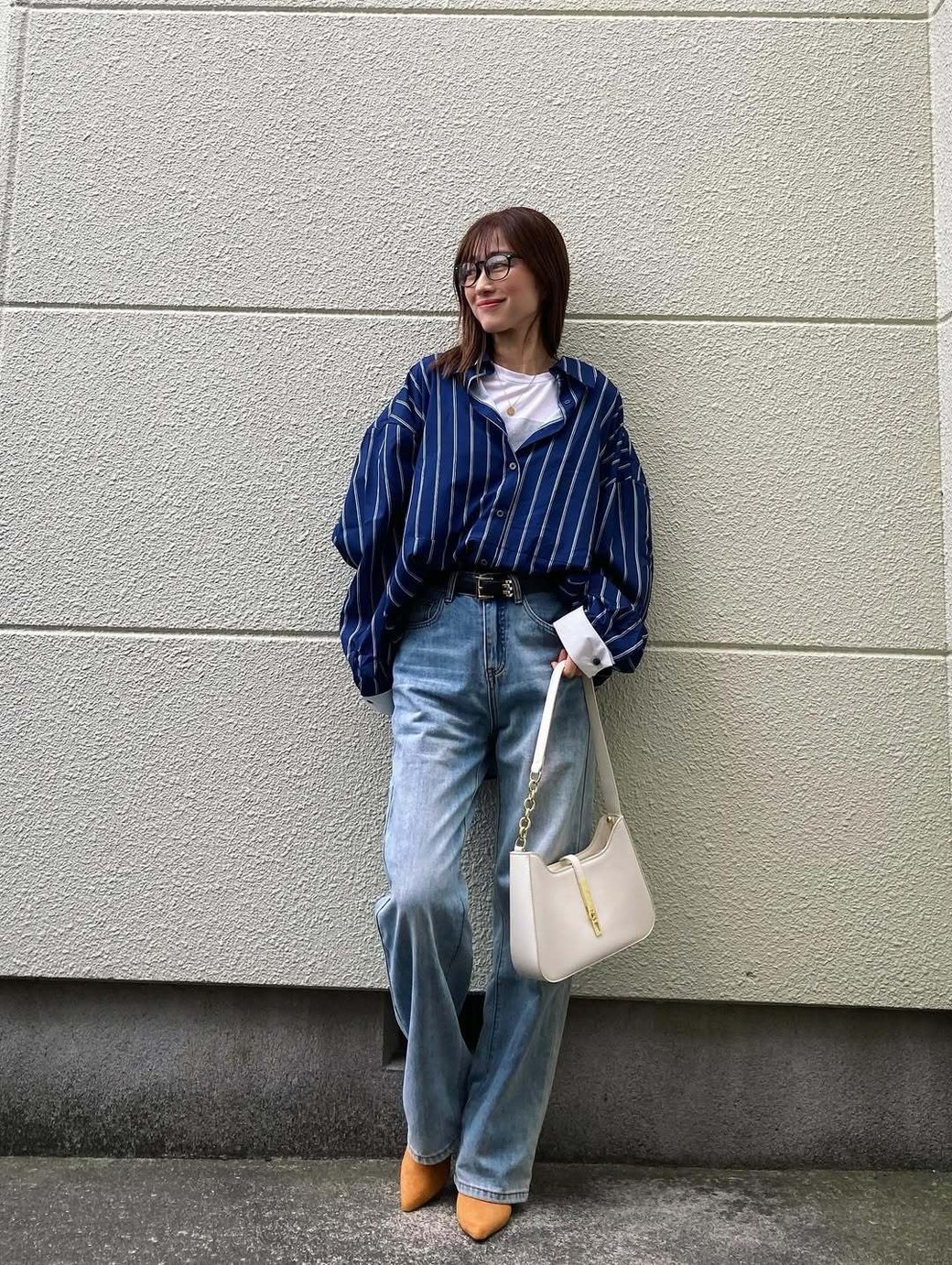 オーバーサイズのシャツはウエストイン＆ベルトでウエストマークして、きれいめな着こなしに。