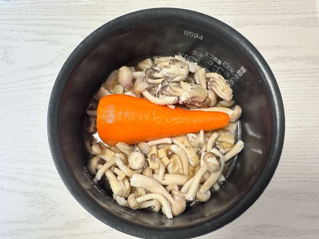 ご飯の上ににんじんや他の具材を置く