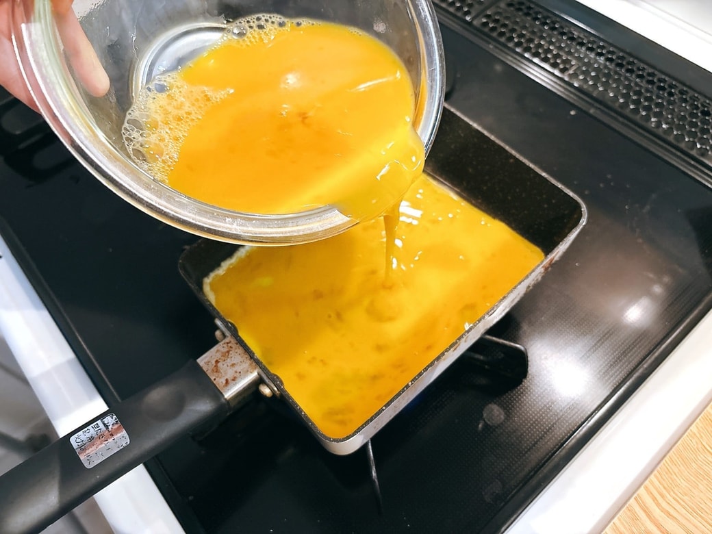 卵液をフライパンに流し入れる