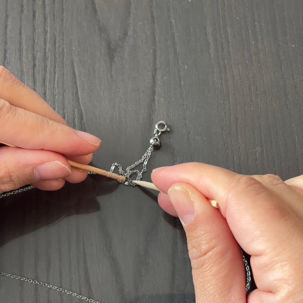 ネックレスの絡まりの隙間を広げているところ