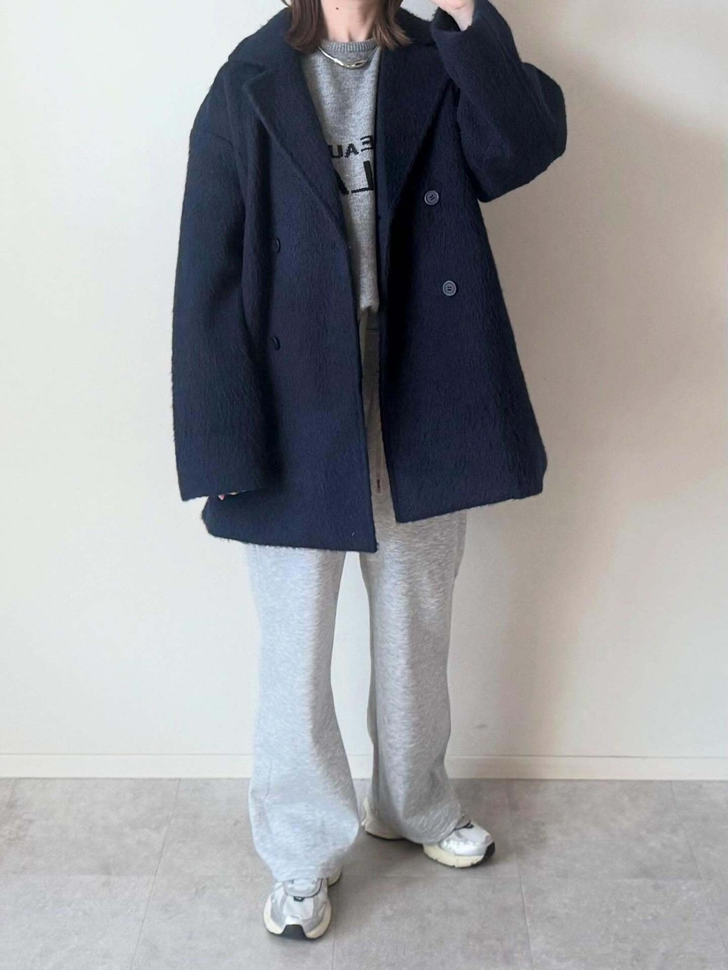 スウェットパンツとスニーカーの色味を合わせた、なじませコーデ。