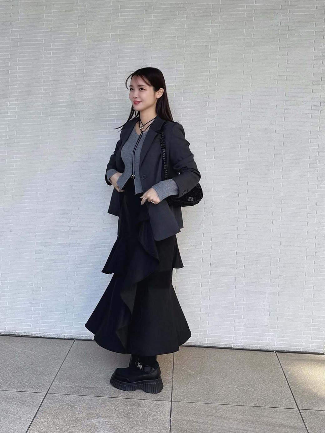 フリルが大胆なモードなスカートに合わせるのは、シンプル＆辛口なトップスが正解。