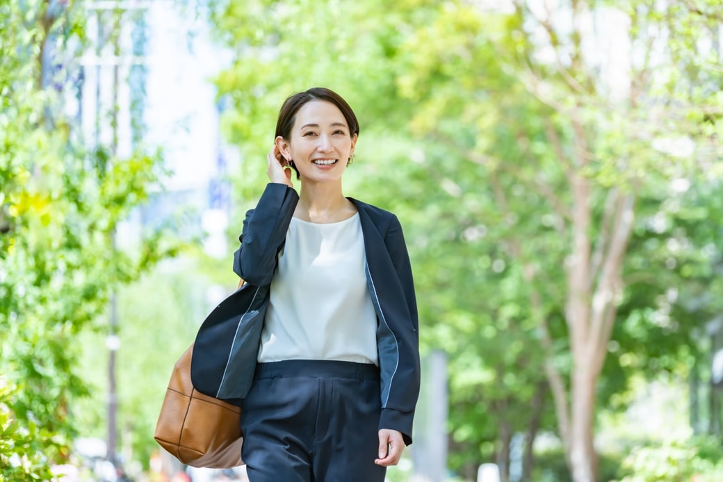 新緑の中歩く女性