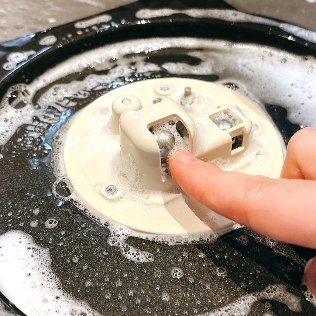 調圧ボールを指で転がして汚れを取る