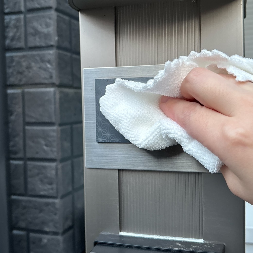 表札の汚れをやさしく拭き取る