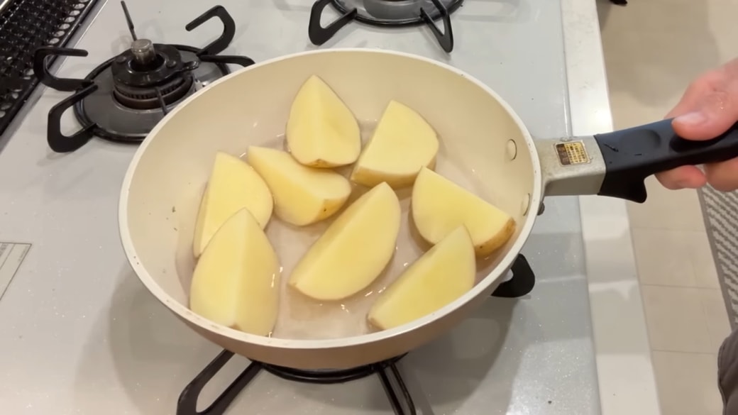 フライパンでじゃがいもを蒸す人