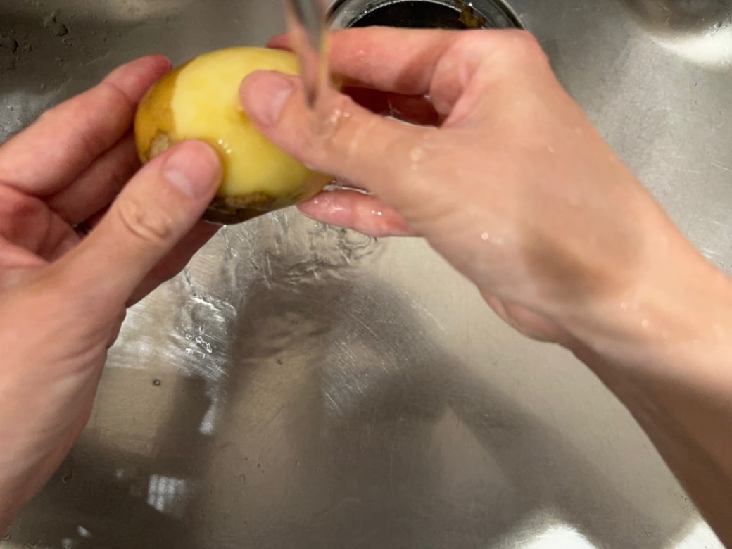 水で流しながら手で皮をむく
