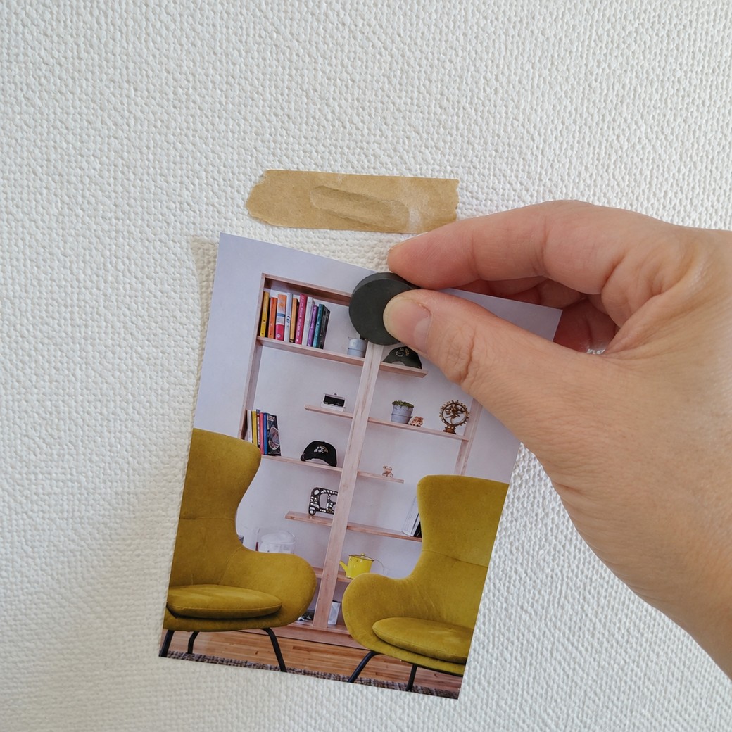 壁に絵を貼る人