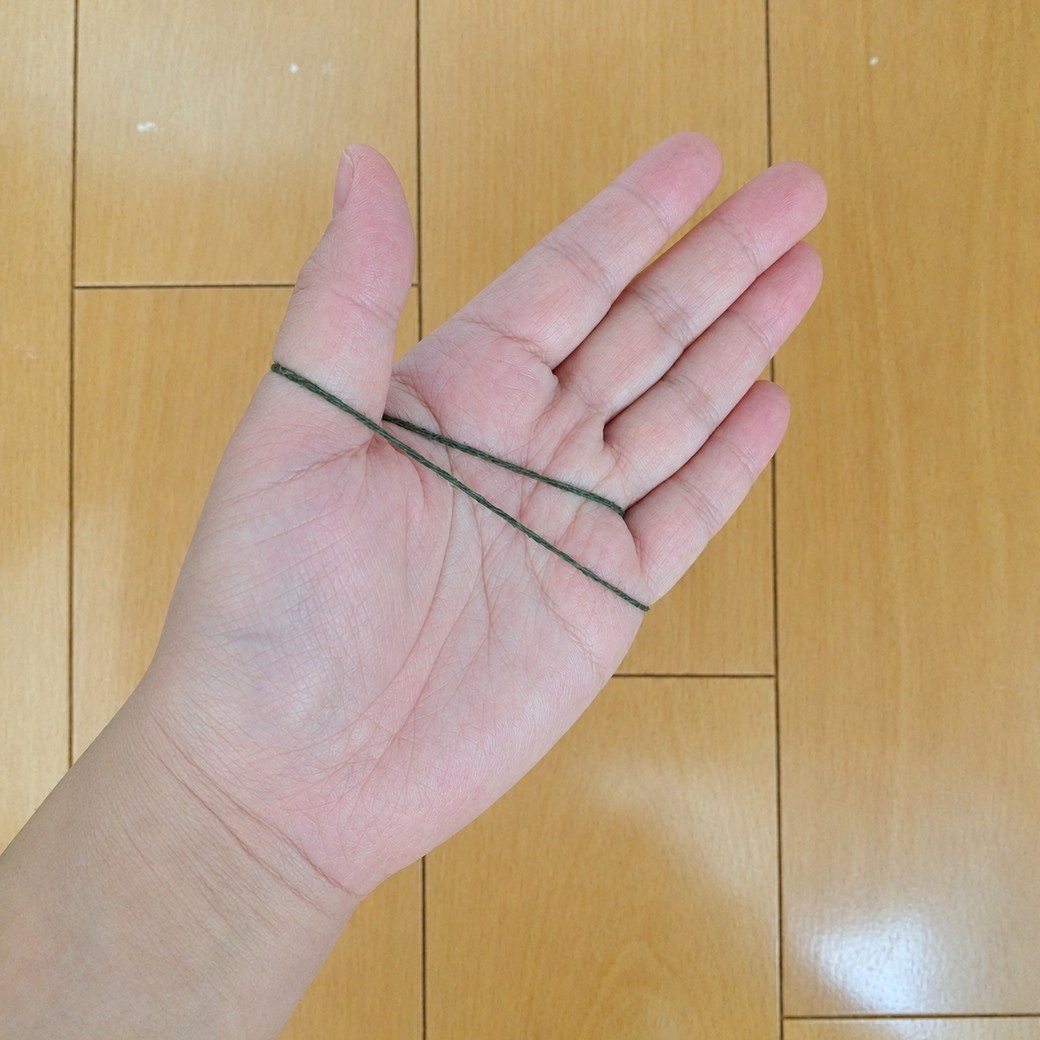 輪ゴムを手に広げる人